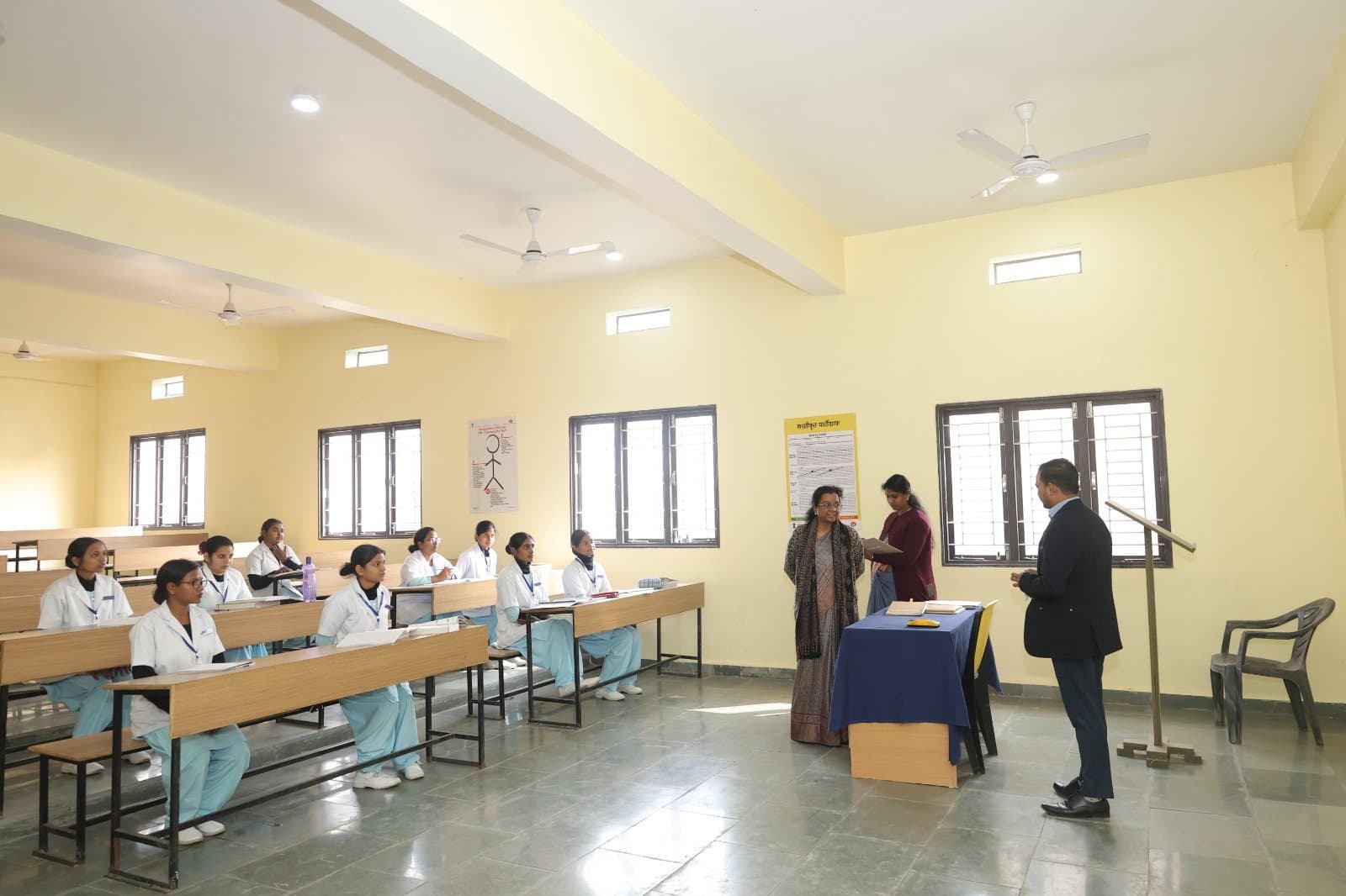 Nursing students in uniform attending a classroom session