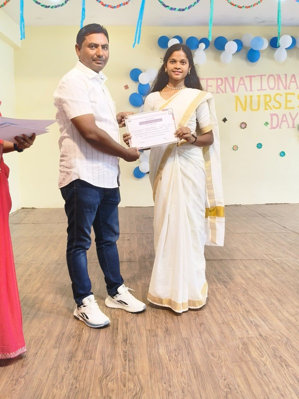 A student receiving a Certificate of Appreciation at the International Nurses Day programme
