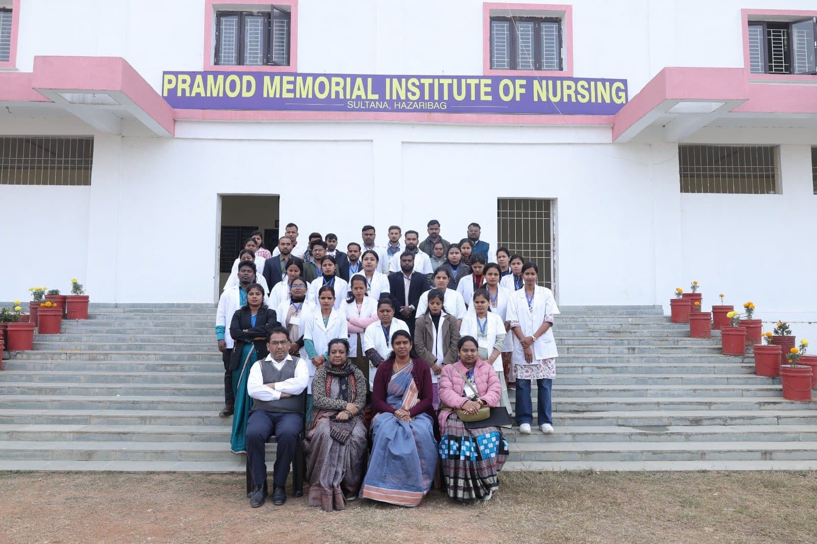 Students and faculty on the front steps of Pramod Memorial Institute of Nursing, Sultana, Hazaribagh